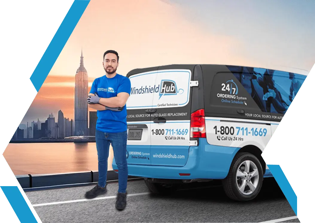 A person standing beside a branded service van with city skyline at sunset